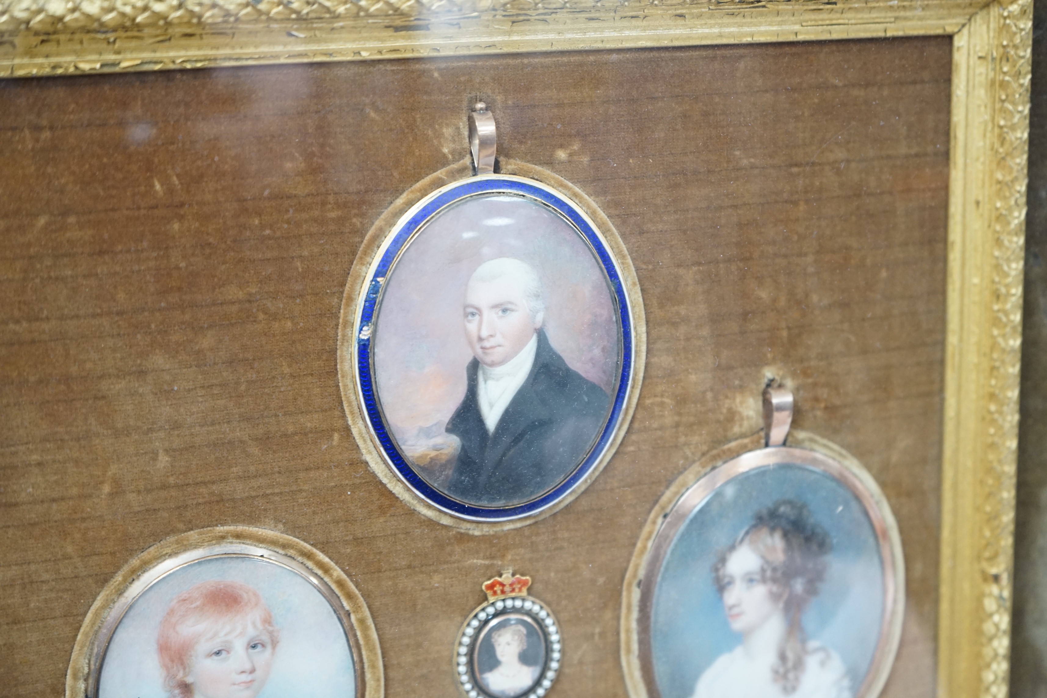 A group of five 19th century portrait miniatures on ivory, framed as one, in a decorative gilt and velvet mount rosewood frame. Overall 36 x 32cm
